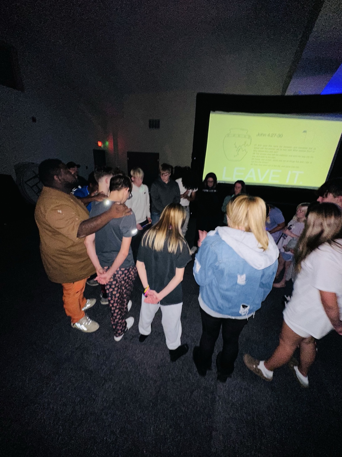 Leaders and students praying together after the message